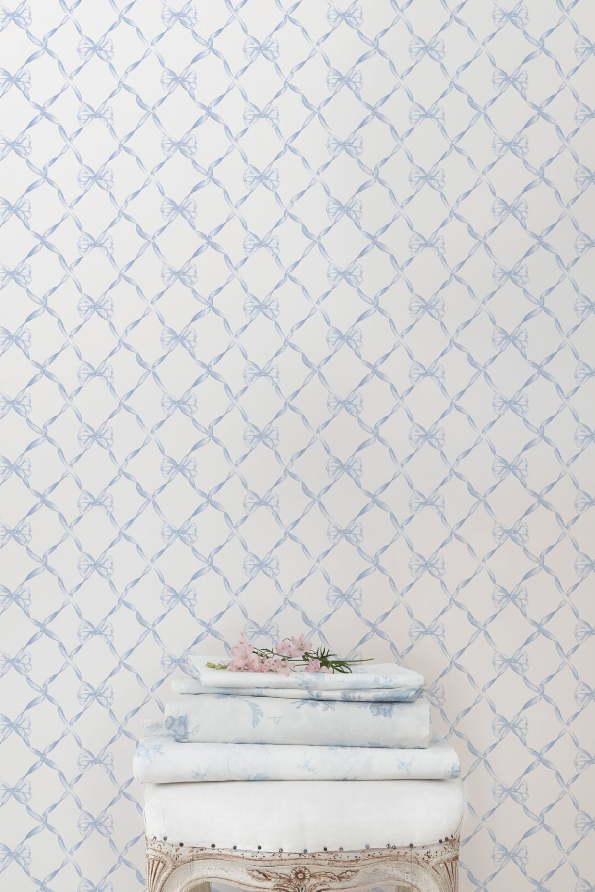 Light blue bow trellis pattern wallpaper on white background.