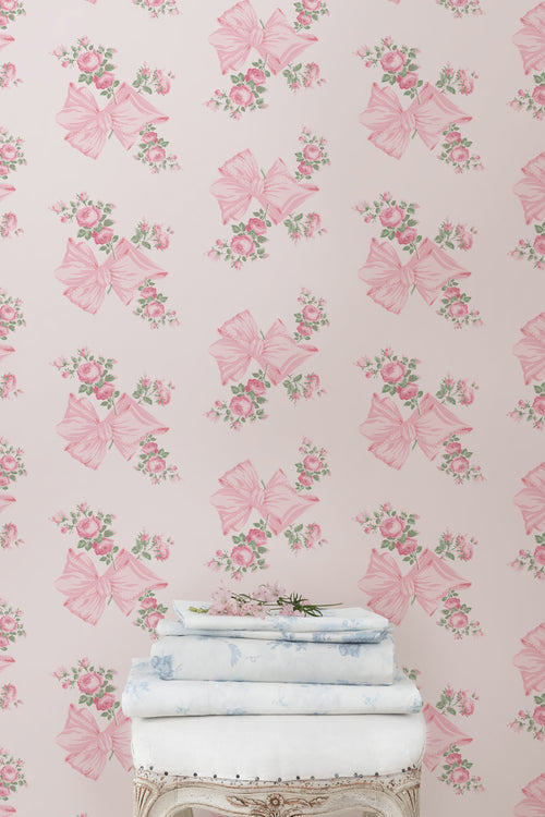Pink and mint floral wallpaper pattern with roses and bow butterflies on a wall