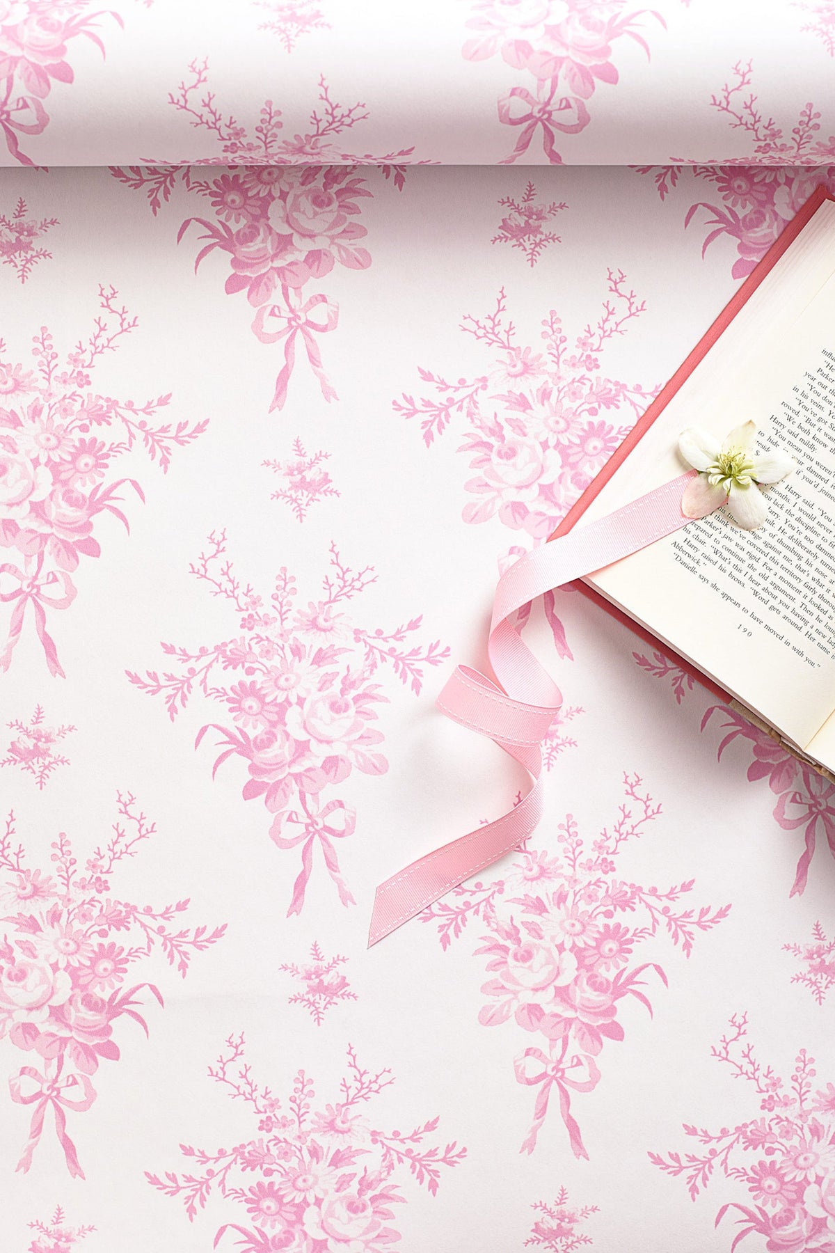 Pink and white floral wallpaper with repeating bouquet silhouettes pattern