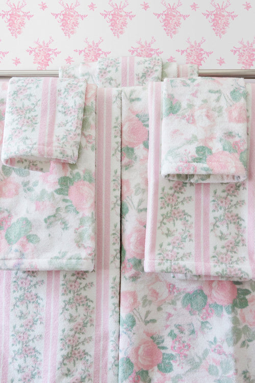 Wallpaper sample panels in pink and green floral print with vertical stripe accents